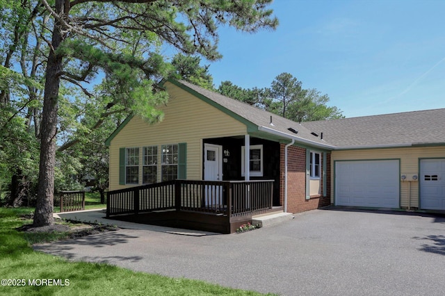 9 Deerfield Dr Unit D, Whiting, NJ 08759 - single story home featuring brick siding, a porch, asphalt driveway, a garage, and a shingled roof