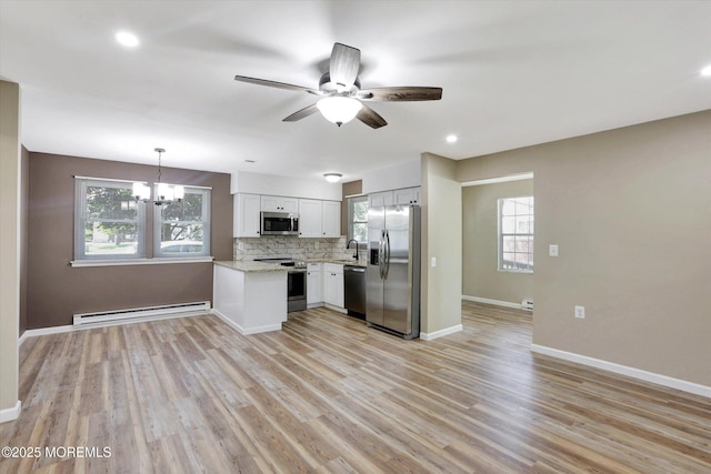 9 Deerfield Dr Unit D, Whiting, NJ 08759 - kitchen with stainless steel appliances, a baseboard radiator, a ceiling fan, a chandelier, and healthy amount of natural light