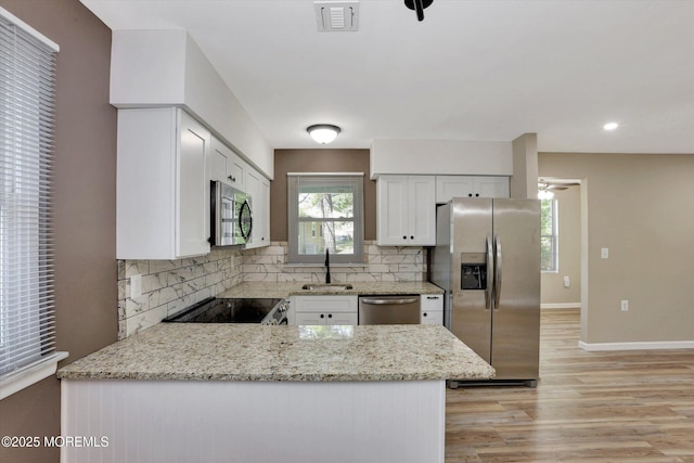 9 Deerfield Dr Unit D, Whiting, NJ 08759 - kitchen with stainless steel appliances, decorative backsplash, light wood-style flooring, a peninsula, and recessed lighting