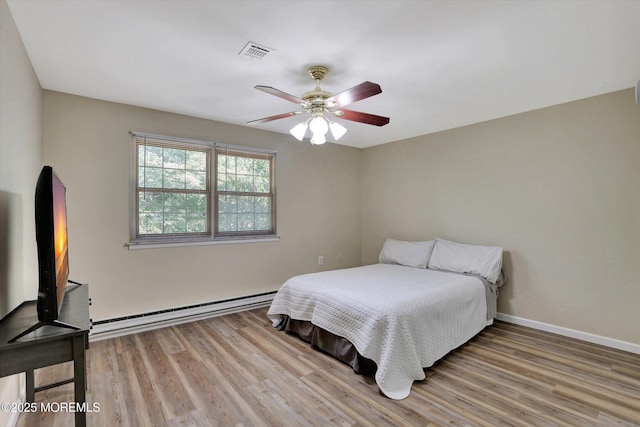9 Deerfield Dr Unit D, Whiting, NJ 08759 - bedroom with a baseboard heating unit, light wood-style flooring, and a ceiling fan