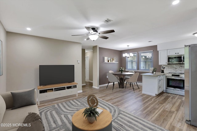 9 Deerfield Dr Unit D, Whiting, NJ 08759 - living room featuring light wood-style flooring, a chandelier, recessed lighting, and a ceiling fan