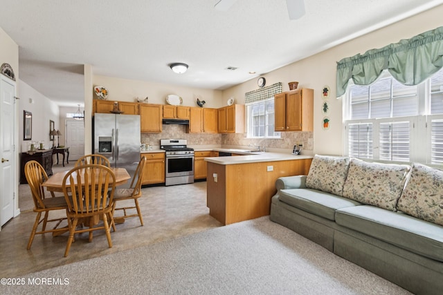18 Osprey Pl, Barnegat, NJ 08005 - kitchen with appliances with stainless steel finishes, open floor plan, backsplash, under cabinet range hood, and light countertops
