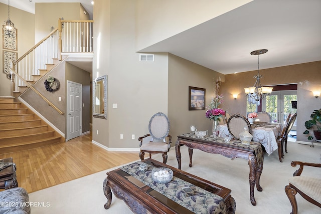 28 Stonehenge Ct, Jackson, NJ 08527 - living area featuring wood finished floors, a chandelier, stairs, and a towering ceiling