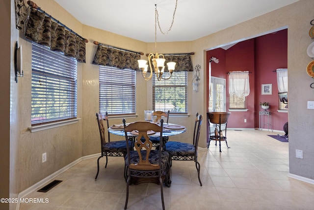 28 Stonehenge Ct, Jackson, NJ 08527 - tiled dining space featuring a chandelier and baseboards