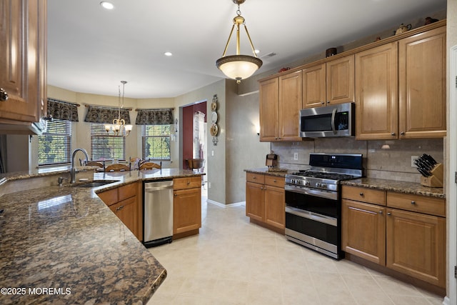 28 Stonehenge Ct, Jackson, NJ 08527 - kitchen featuring stainless steel appliances, a chandelier, decorative backsplash, decorative light fixtures, and dark stone counters