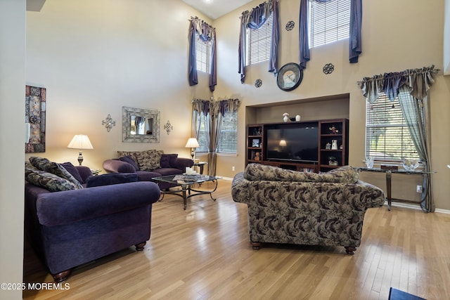 28 Stonehenge Ct, Jackson, NJ 08527 - living room featuring light wood finished floors and a towering ceiling