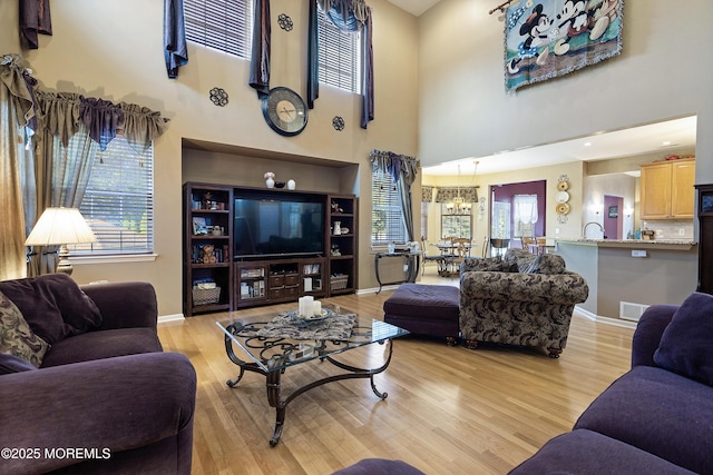 28 Stonehenge Ct, Jackson, NJ 08527 - living room with a chandelier, light wood-type flooring, and a towering ceiling