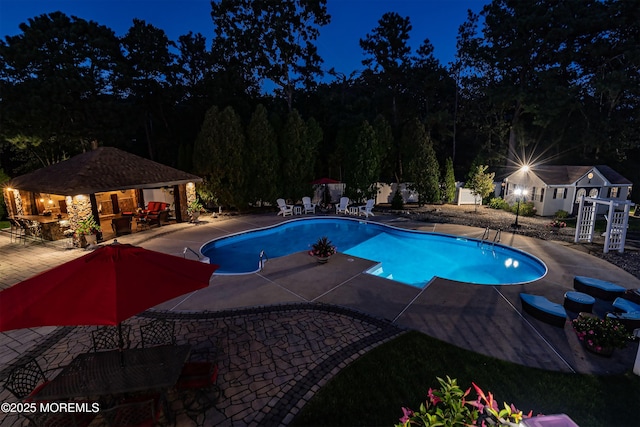 28 Stonehenge Ct, Jackson, NJ 08527 - pool at twilight with a patio, an outdoor pool, and an outdoor structure