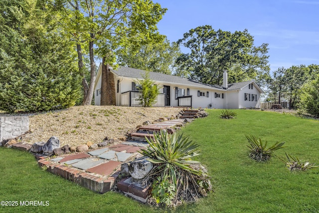 1822 Deerhead Lake Dr, Forked River, NJ 08731 - view of front of house featuring a front lawn, stucco siding, and a chimney