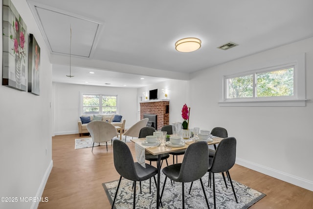 1822 Deerhead Lake Dr, Forked River, NJ 08731 - dining area featuring attic access, healthy amount of natural light, a brick fireplace, light wood-style flooring, and recessed lighting