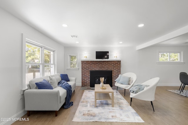 1822 Deerhead Lake Dr, Forked River, NJ 08731 - living area with plenty of natural light, wood finished floors, a brick fireplace, and recessed lighting