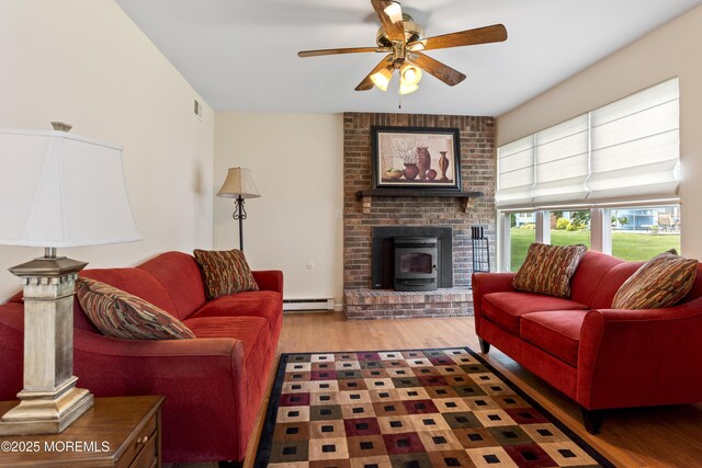 16 Saint Paul Pl, Manchester, NJ 08759 - living area with a baseboard heating unit, wood finished floors, ceiling fan, and a brick fireplace