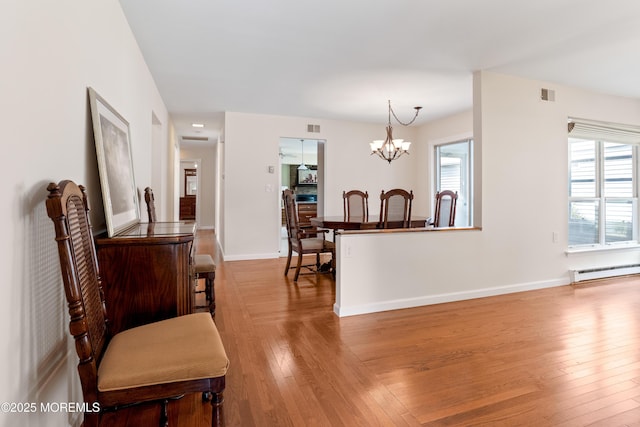 16 Saint Paul Pl, Manchester, NJ 08759 - dining space featuring a baseboard heating unit, wood finished floors, and a chandelier