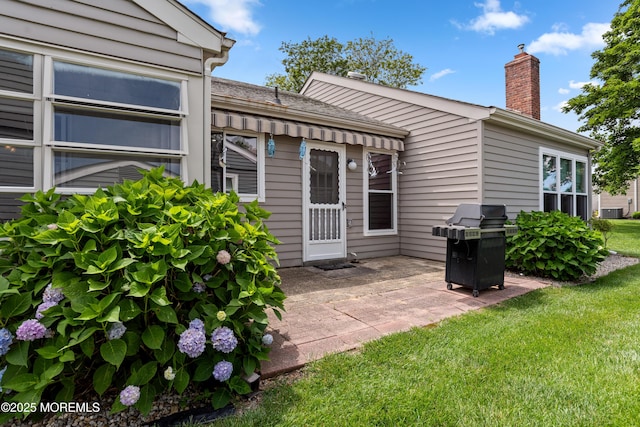 16 Saint Paul Pl, Manchester, NJ 08759 - back of property with a patio area, a chimney, and a yard