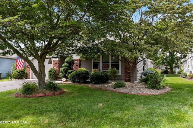 16 Saint Paul Pl, Manchester, NJ 08759 - view of property hidden behind natural elements with brick siding, a front lawn, and driveway