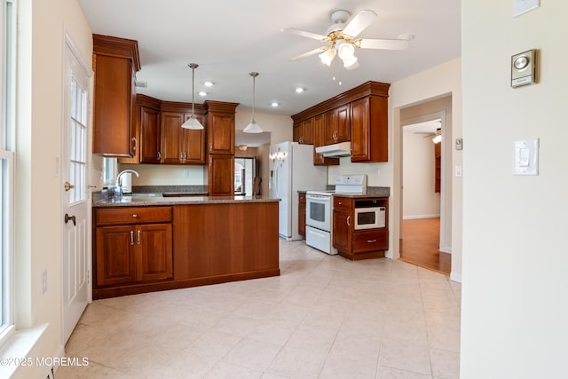 16 Saint Paul Pl, Manchester, NJ 08759 - kitchen with white appliances, a ceiling fan, under cabinet range hood, a peninsula, and brown cabinetry