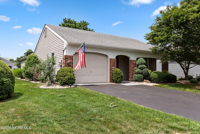16 Saint Paul Pl, Manchester, NJ 08759 - view of front facade with brick siding, a garage, a front yard, driveway, and roof with shingles