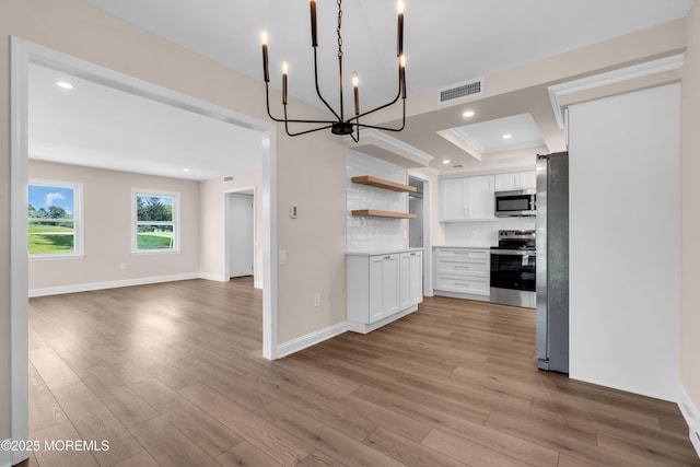 377 Old Nassau Rd Unit 377B, Monroe, NJ 08831 - kitchen featuring stainless steel appliances, white cabinetry, open shelves, a chandelier, and open floor plan