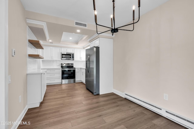 377 Old Nassau Rd Unit 377B, Monroe, NJ 08831 - kitchen with appliances with stainless steel finishes, a baseboard heating unit, open shelves, light wood finished floors, and white cabinets