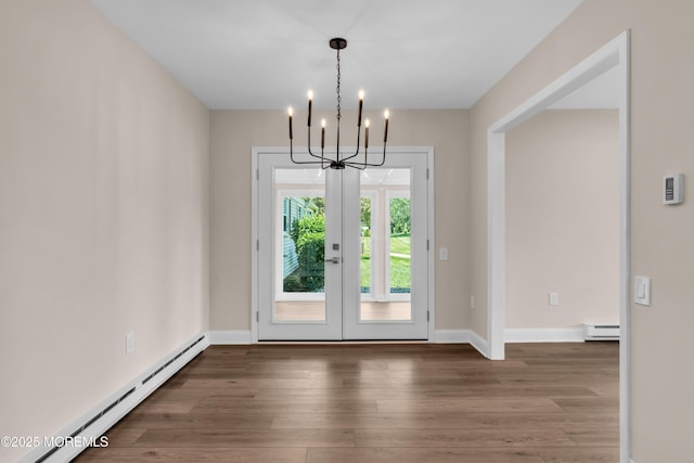 377 Old Nassau Rd Unit 377B, Monroe, NJ 08831 - unfurnished dining area featuring a baseboard radiator, french doors, a chandelier, and wood finished floors