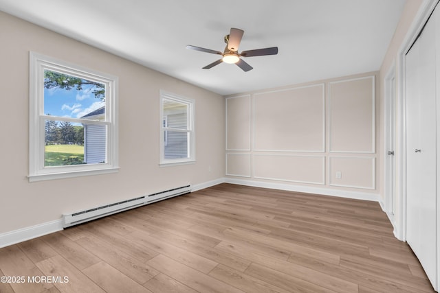 377 Old Nassau Rd Unit 377B, Monroe, NJ 08831 - unfurnished room featuring a baseboard radiator, a decorative wall, ceiling fan, and light wood finished floors
