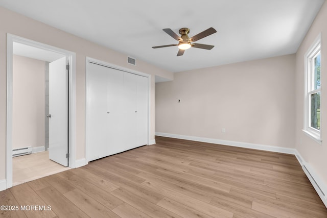 377 Old Nassau Rd Unit 377B, Monroe, NJ 08831 - unfurnished bedroom with baseboard heating, light wood finished floors, a closet, and ceiling fan