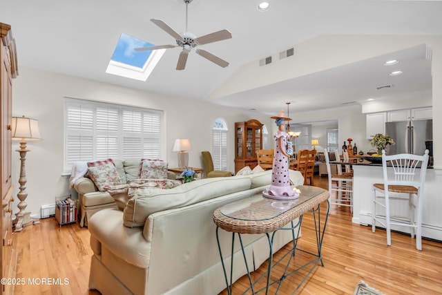 217 Howe St, Point Pleasant, NJ 08742 - living room with a ceiling fan, lofted ceiling, plenty of natural light, a skylight, and light wood finished floors