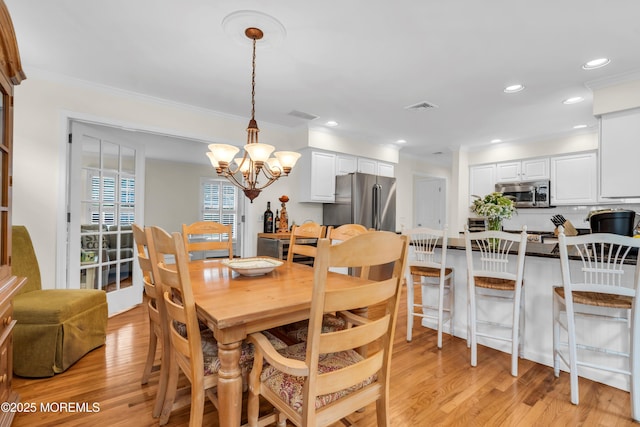 217 Howe St, Point Pleasant, NJ 08742 - dining room featuring light wood finished floors, a chandelier, crown molding, and recessed lighting