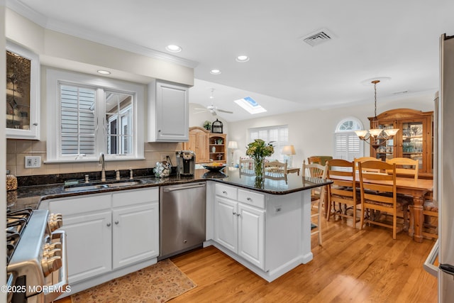 217 Howe St, Point Pleasant, NJ 08742 - kitchen featuring stainless steel dishwasher, range, a peninsula, recessed lighting, and light wood-style floors