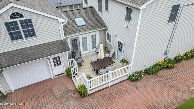 217 Howe St, Point Pleasant, NJ 08742 - view of home's exterior with roof with shingles, a wooden deck, and a garage