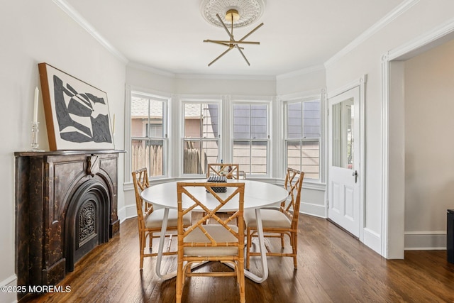 132 Cookman Ave, Ocean Grove, NJ 07756 - dining room with dark wood-style floors, a fireplace, crown molding, and a chandelier