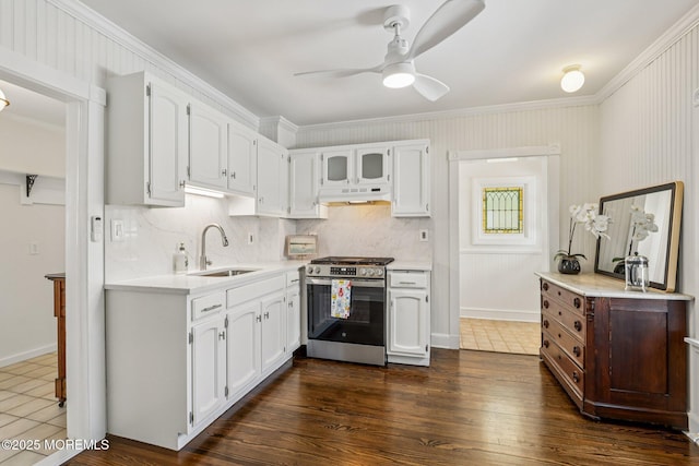 132 Cookman Ave, Ocean Grove, NJ 07756 - kitchen featuring stainless steel gas range, under cabinet range hood, light countertops, ornamental molding, and white cabinets