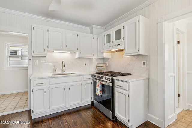 132 Cookman Ave, Ocean Grove, NJ 07756 - kitchen with stainless steel gas range, under cabinet range hood, white cabinetry, backsplash, and light countertops