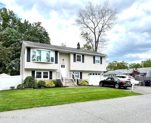 645 Ensign Ave, Beachwood, NJ 08722 - split foyer home featuring driveway, a chimney, and a garage
