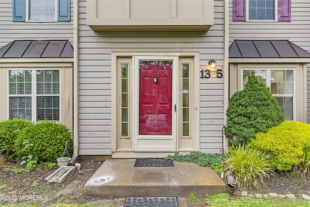 13 Stuart Dr Unit 5, Freehold, NJ 07728 - view of exterior entry with a standing seam roof and a metal roof