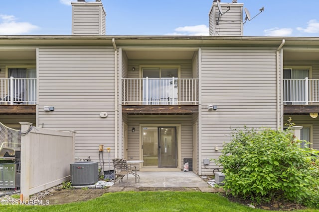 13 Stuart Dr Unit 5, Freehold, NJ 07728 - rear view of house with a balcony, a chimney, and a patio