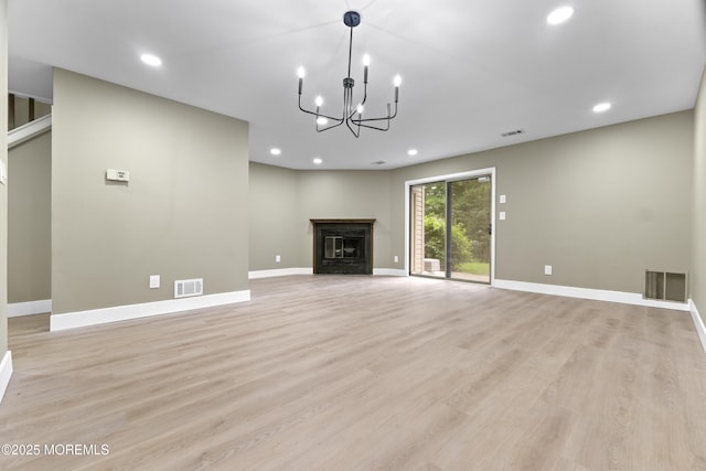 13 Stuart Dr Unit 5, Freehold, NJ 07728 - unfurnished living room featuring light wood-style floors, recessed lighting, a chandelier, and a fireplace