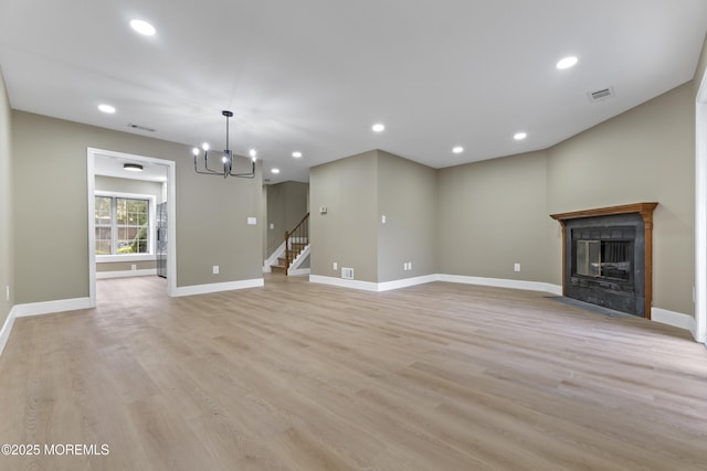 13 Stuart Dr Unit 5, Freehold, NJ 07728 - unfurnished living room featuring a chandelier, light wood finished floors, a fireplace with flush hearth, recessed lighting, and stairway