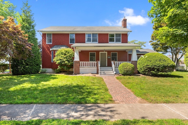 217 Alpern Ave, Elberon, NJ 07740 - view of front facade featuring a chimney, a porch, and a front lawn