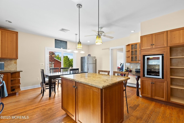 217 Alpern Ave, Elberon, NJ 07740 - kitchen featuring freestanding refrigerator, backsplash, brown cabinets, and recessed lighting