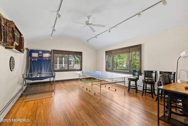 217 Alpern Ave, Elberon, NJ 07740 - recreation room with rail lighting, a baseboard radiator, vaulted ceiling, wood finished floors, and a ceiling fan