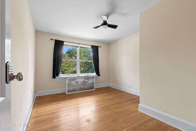 217 Alpern Ave, Elberon, NJ 07740 - unfurnished room with light wood-style flooring, ceiling fan, and radiator heating unit