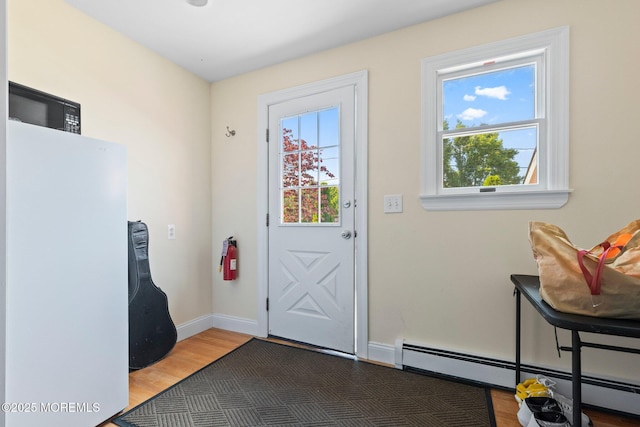 217 Alpern Ave, Elberon, NJ 07740 - doorway with a baseboard heating unit and wood finished floors