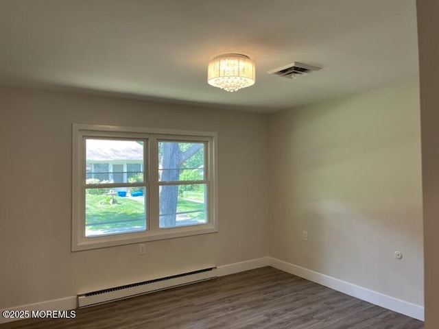 482C Thornbury Ct, Lakewood, NJ 08701 - empty room featuring a baseboard radiator, dark wood-style flooring, and a chandelier