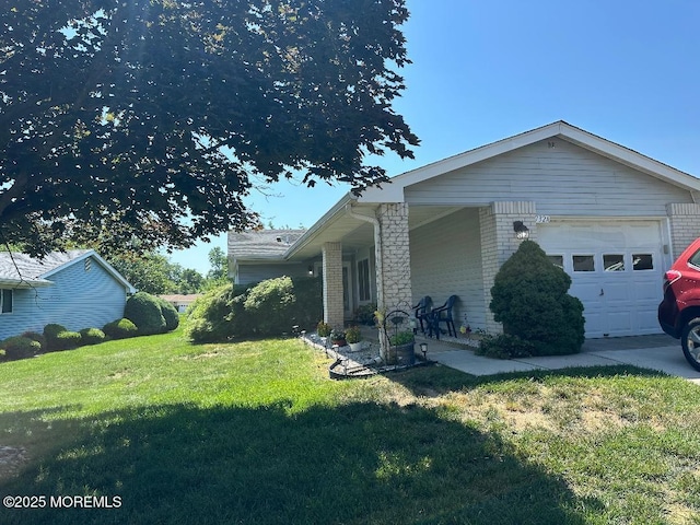 732 Ralston Plz Unit 732A, Monroe, NJ 08831 - view of property exterior with a lawn, brick siding, an attached garage, and covered porch