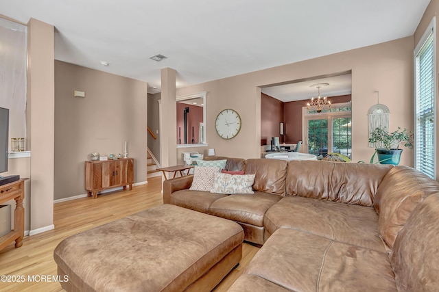 27 Skyline Dr, Hazlet, NJ 07730 - living room with light wood finished floors, stairway, a chandelier, and plenty of natural light