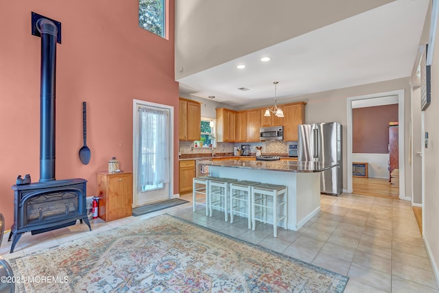 27 Skyline Dr, Hazlet, NJ 07730 - kitchen with stainless steel appliances, a kitchen breakfast bar, a wood stove, a center island, and backsplash