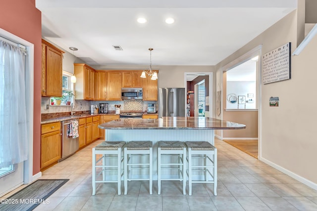 27 Skyline Dr, Hazlet, NJ 07730 - kitchen featuring stainless steel appliances, a kitchen breakfast bar, backsplash, dark stone counters, and recessed lighting