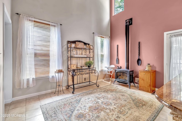 27 Skyline Dr, Hazlet, NJ 07730 - sitting room with tile patterned flooring, a wood stove, and a high ceiling