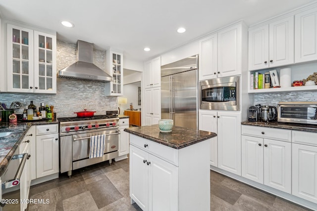 11 Delwood Rd, Chester Twp, NJ 07930 - kitchen with wall chimney exhaust hood, built in appliances, decorative backsplash, white cabinetry, and recessed lighting